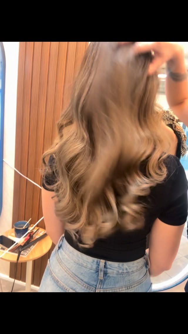 Glänzende Balayage-Locken in Karamell und Honigtönen